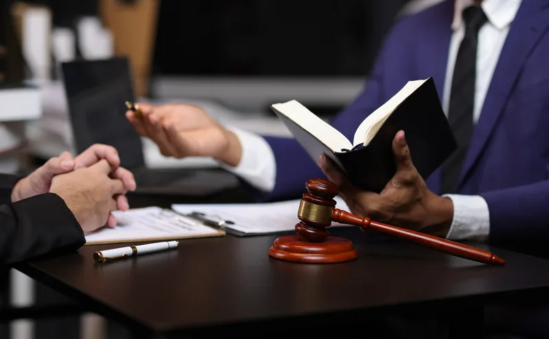 Attorney reviewing legal documents with a client during a legal consultation.