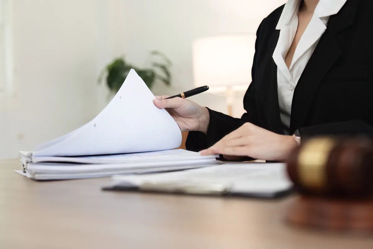 Legal professional reviewing case documents, illustrating the process of evaluating financial losses and compensation in a North Carolina wrongful death claim.